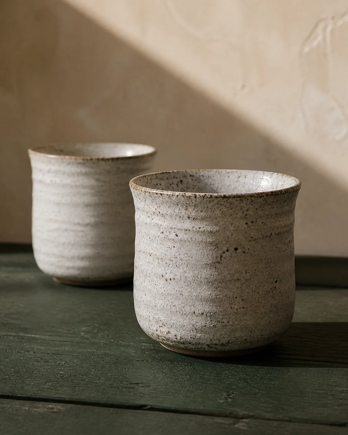 Two speckled hand-thrown stoneware cups