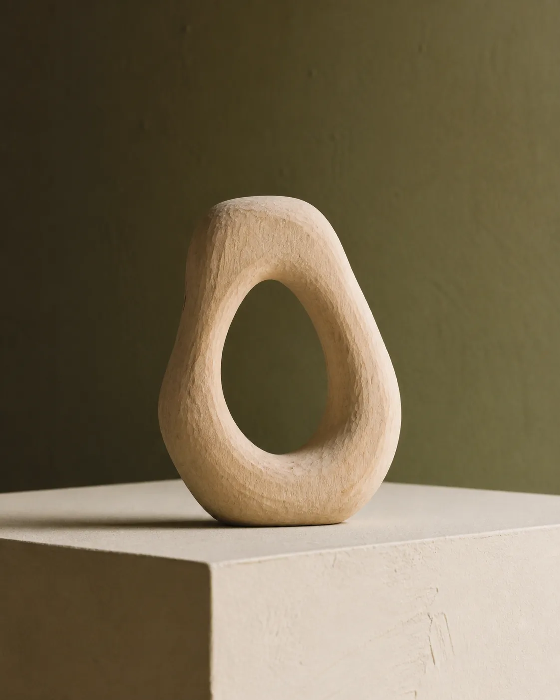Abstract loop sculpture hand carved from pale timber